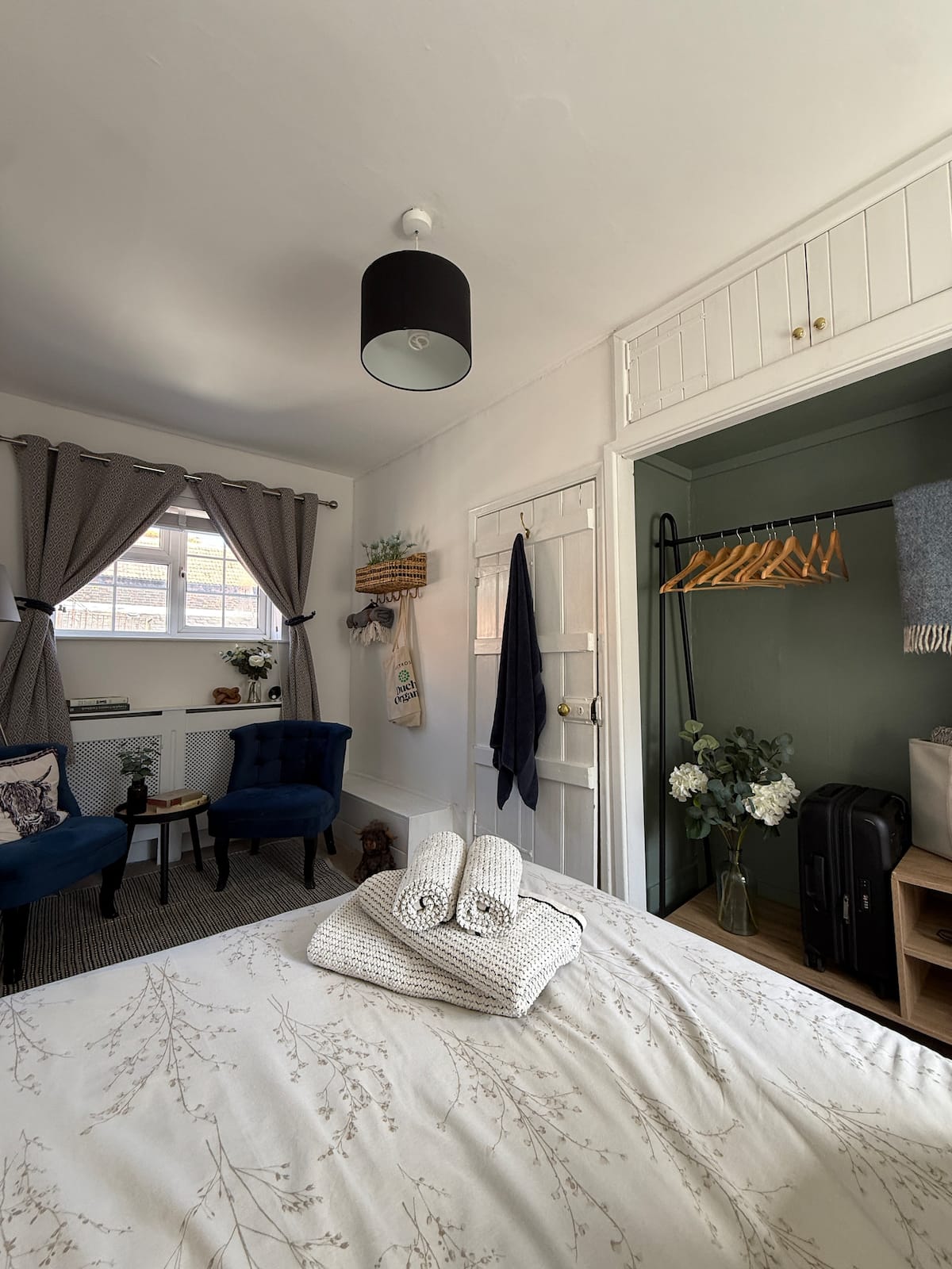 Bedroom two — double bed with sage-green wardrobe nook